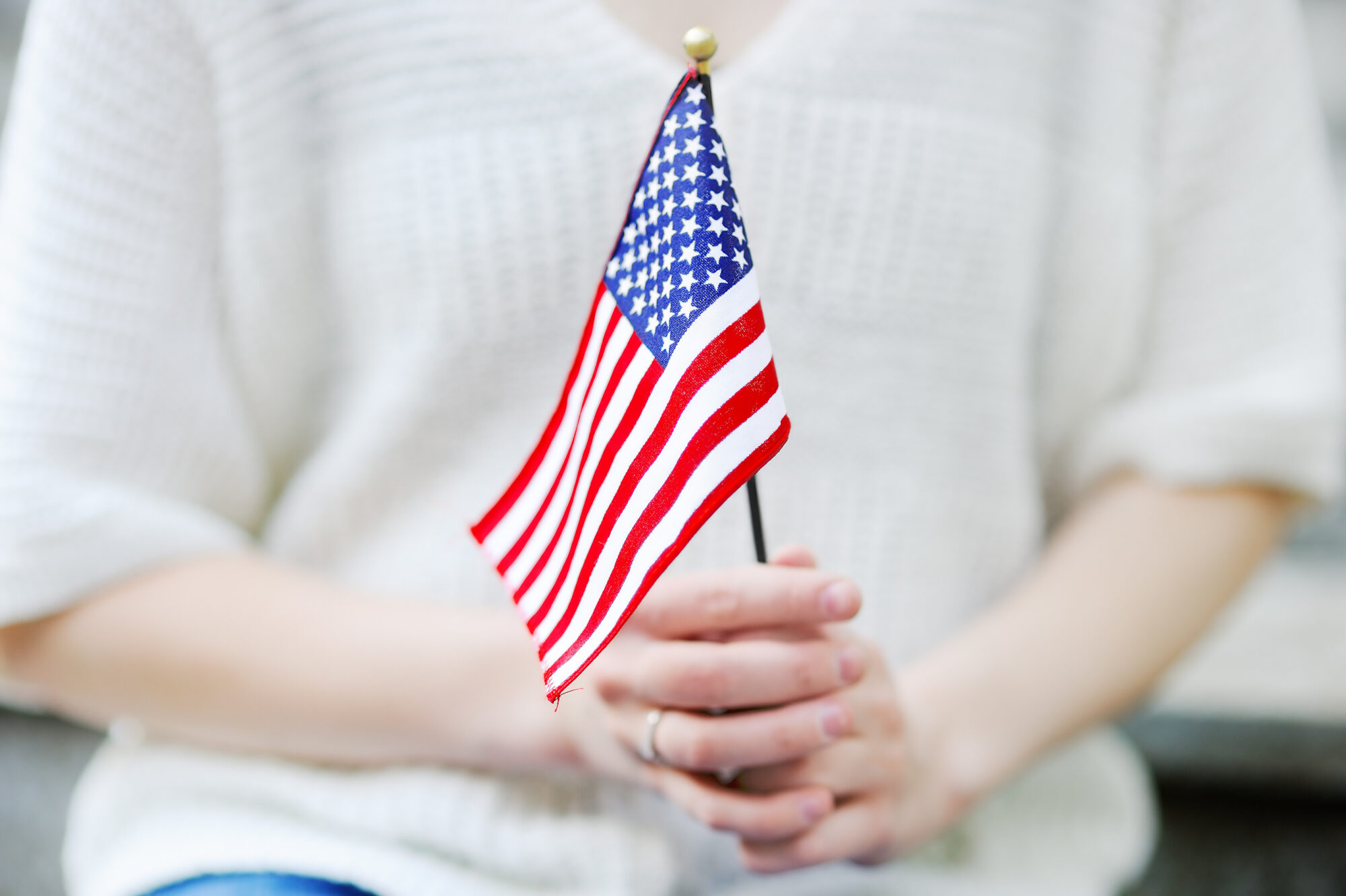 Young woman holding american flag close up